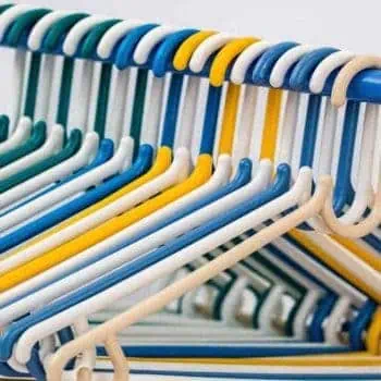 Multi-colored clothes hangers in packed closet