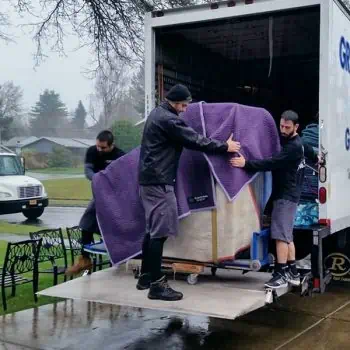 Movers in Euless TX moving furniture in the rain