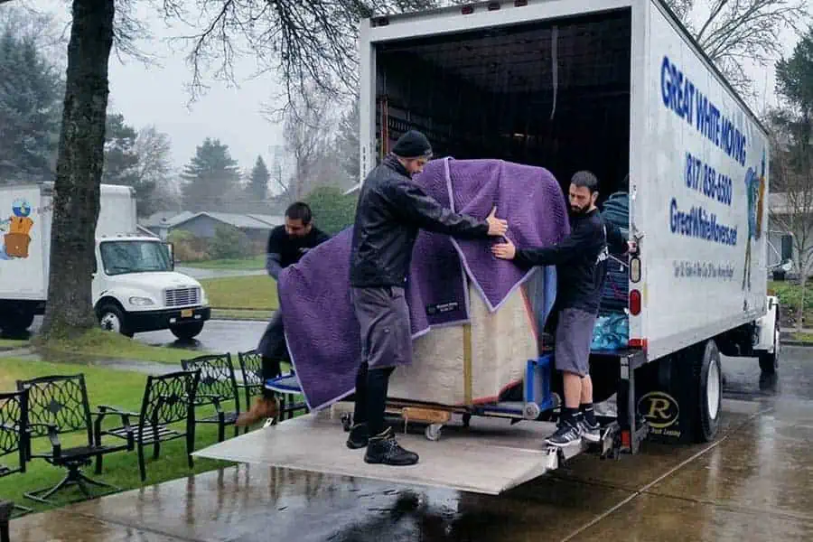 Movers in Euless TX moving furniture in the rain