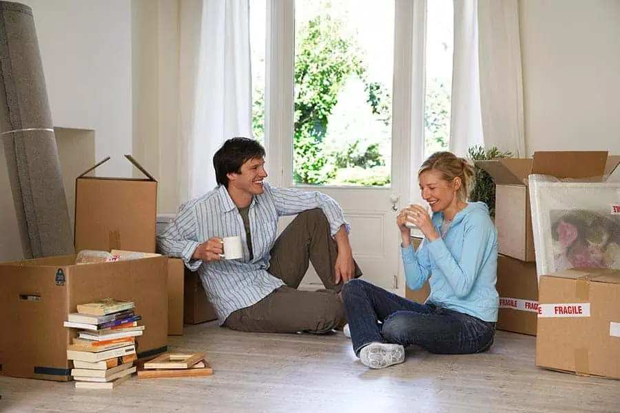 Happy couple taking a break during a move