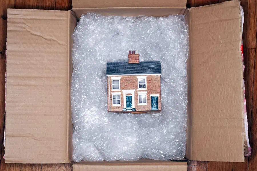 Model of a house in a box padded with bubble wrap, packed by our Southlake TX movers