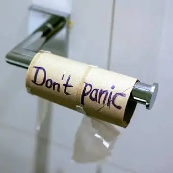 Empty toilet paper roll with the words "don't panic" written - movers in Grapevine, Tx