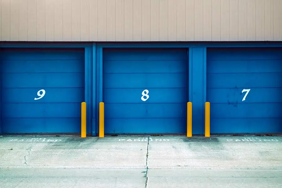 A row of numbered storage units with blue doors